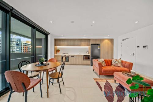 a living room with a couch and a table at PerthViews Modern with Pool Gym in Perth