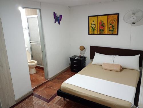 Postel nebo postele na pokoji v ubytování Hotel Iam Armenia Quindio