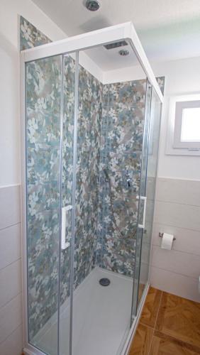 a shower with a glass enclosure in a bathroom at Villini Florence Boutique in Lido di Fermo