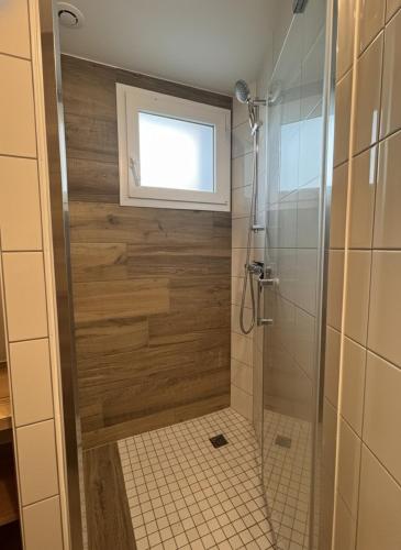 a bathroom with a shower with a window at Quartier du Roy -15min du Parc -by R&G in La Pommeraie-sur-Sèvre
