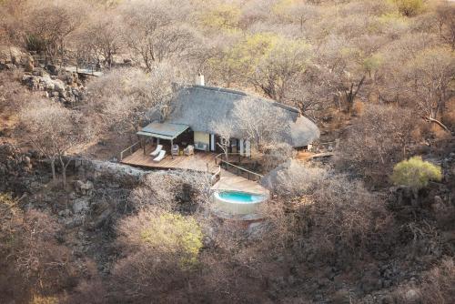 an aerial view of a house with a swimming pool at Little Ongava in Okaukuejo