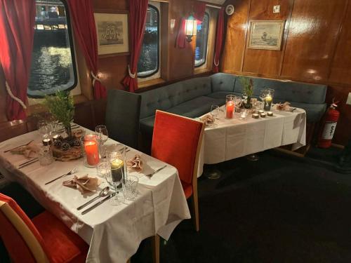 two tables in a train dining car with candles at Norwegian Fjord Explorer Line in Tromsø