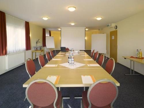 a large conference room with a long table and chairs at Hotel Schoch in Mainhardt