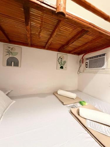 a room with a bed and a air conditioner at Beach Side Cabin San Juan ELYU in San Juan