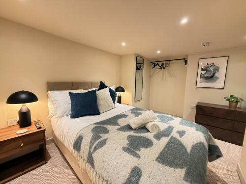 a bedroom with a large bed with blue pillows at The Meridian in Southport