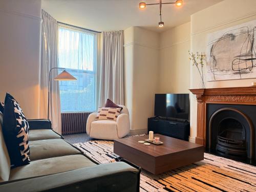 a living room with a couch and a fireplace at The Meridian in Southport
