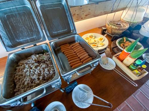 a table with a tray of food on a table at Chumphon Cabana Resort in Chumphon