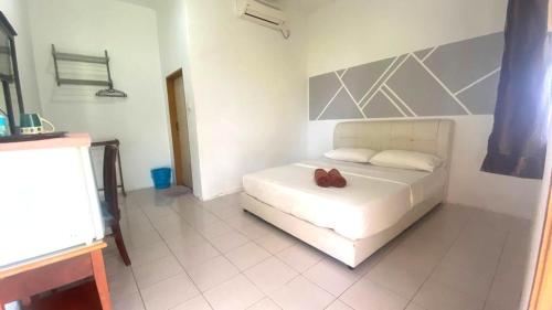 Φωτογραφία από το άλμπουμ του Capital O 91246 Tokman Inn σε Pantai Cenang