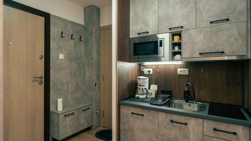 A kitchen or kitchenette at City Square Apartment