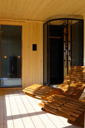 a wooden bench on the front porch of a house at Silva SPA in Goszczyce Średnie