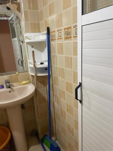 a bathroom with a sink and a toilet and a mirror at Rest in Agadir