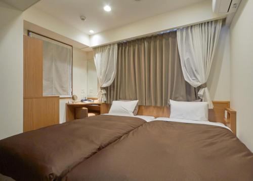 Ένα ή περισσότερα κρεβάτια σε δωμάτιο στο unito hotel residence Kyoto Station North