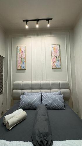 a large bed with two pillows on top of it at ADS House Padalarang - Guesthouse Aesthetic in Padalarang