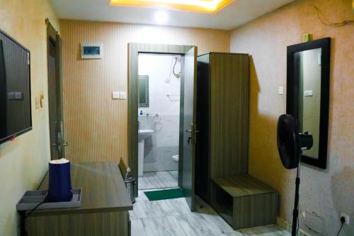 a bathroom with a shower and a toilet and a sink at House 32 Hotels and Suites in Lagos
