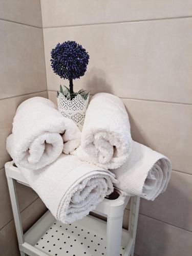 a pile of towels sitting on a stool in a bathroom at Studio Mimika in Perissa