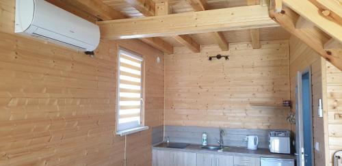 a wooden room with a sink and a window at Nautica in Gąski