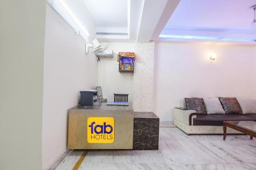 a living room with a couch and a table at FabHotel South Paradise in New Delhi