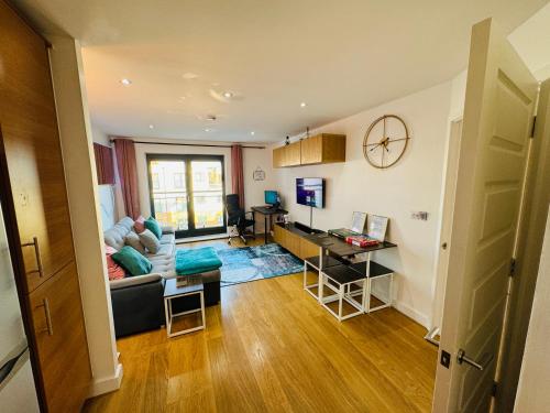 a living room with a couch and a desk at The Windy Smart Home, you will love it in Grays Thurrock