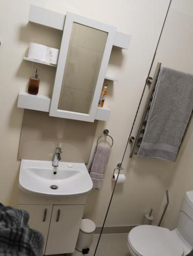 a bathroom with a sink and a mirror at Melkbos Corner in eMalahleni