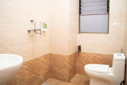 a bathroom with a toilet and a sink at Aarya Wellness & Hostel in Kathmandu