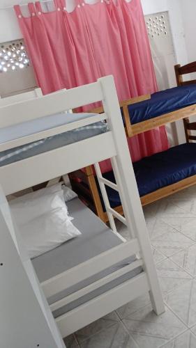 En eller flere senge i et værelse på Suítes Da Lady