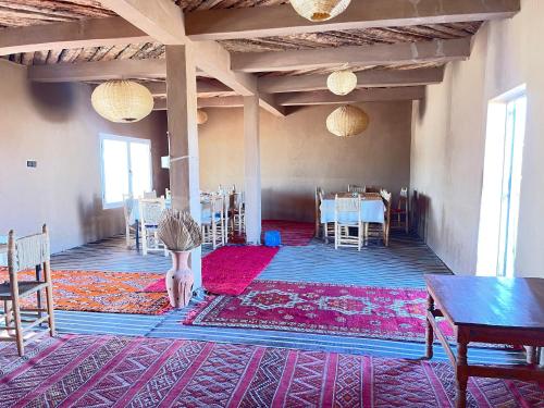 a young child is standing on a rug in a room at Chegaga Starlight Camp - Mhamid Desert Haven in Mhamid
