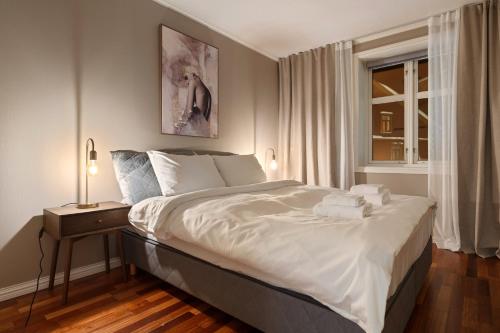 een slaapkamer met een groot wit bed en een raam bij ARCTIC HOMES - Harmony Retreat in Tromsø