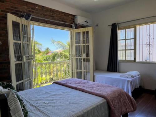 En eller flere senge i et værelse på Village Itaúna Inn - Casas de Temporada