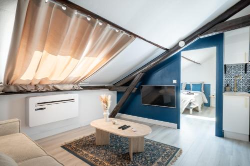 un salon avec un canapé et une table dans l'établissement Le Douillet, à Reims