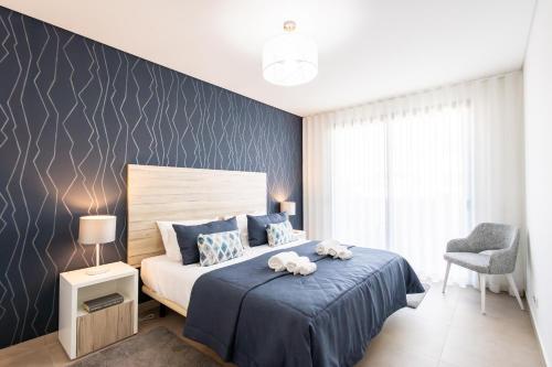 En eller flere senge i et værelse på Villa Mariana