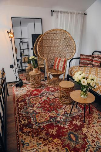 a living room with a bed and chairs and a rug at Open Concept Boutique Hotel - free breakfast & parking in Belgrade