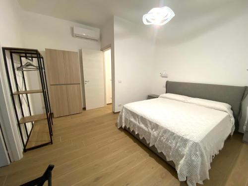 a bedroom with a white bed and a mirror at A casa di Adele in Taormina