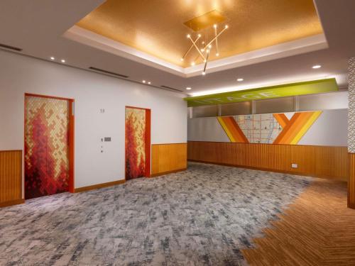 a large room with paintings on the walls at ibis Styles Kyoto Shijo in Kyoto