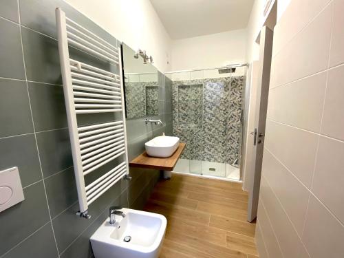 a bathroom with a sink and a toilet and a shower at A casa di Adele in Taormina
