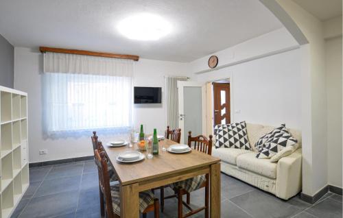 a living room with a table and a couch at Nice Home In Longarone With Wifi in Faè