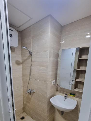 a bathroom with a sink and a shower at Apartemen Springwood by tuliproom in Pakulonan Dua