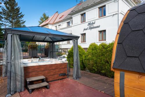 a bath tub with a canopy in front of a building at Wellness & SPA boutique Hotel pod lipkami Prague in Prague
