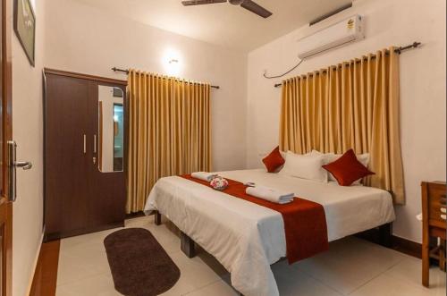 a bedroom with a bed and a shower in it at The Panakal Boho in Cochin