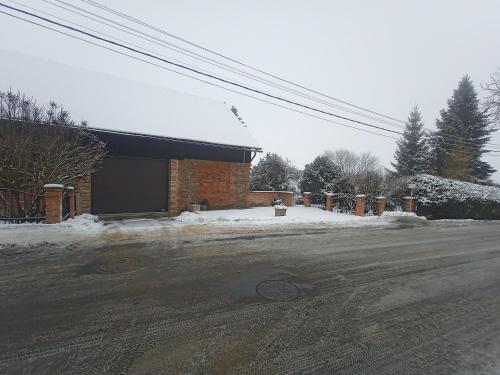 a building on a street with snow on the ground at Family apartment Vysočina SKI plus BIATLON in Nové Město na Moravě