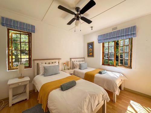 En eller flere senge i et værelse på Arkelshoek Cottages