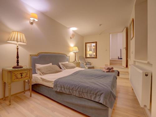 ein Schlafzimmer mit einem Bett und einem Tisch mit einer Lampe in der Unterkunft Old Town Doma View 1BR Stays in Riga