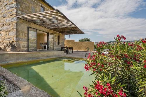 a garden with a pool in front of a house at Romantic Lemon Grove Cottage with Private Pool - Oporto Lemon Farm, near Porto in Valpedre