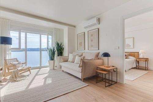 a living room with a couch and a table at Blue Ocean Deluxe in Sanxenxo