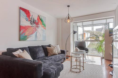 a living room with a couch and a table at Blue Ocean Apartment in A Coruña