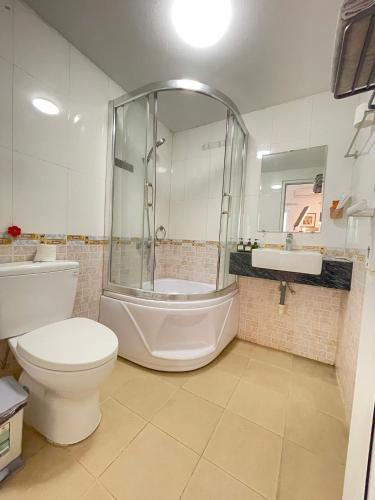 a bathroom with a shower and a toilet and a sink at CHILLING SUDIO 11 Trinh Cong Son close Ho Tay vs Lotte mail ! in Hanoi