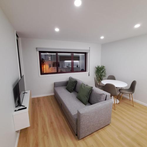 a living room with a couch and a table at Alameda Apartments 2 in Trofa