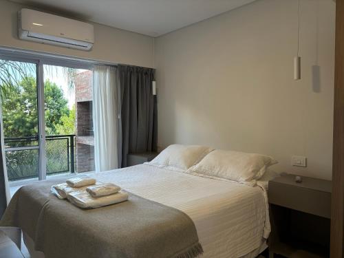 a bedroom with a bed with two towels on it at TOLHUIN COLON in Colón
