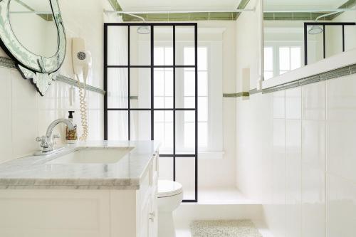 a white bathroom with a sink and a toilet at Central Hollywood Homestay Getaway in Los Angeles
