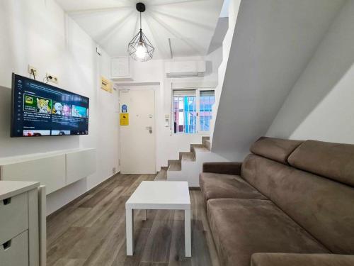 a living room with a couch and a table at Apartalux Villa Playa in Benidorm