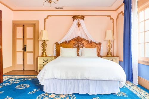 a bedroom with a large white bed with a canopy at Central Hollywood Homestay Getaway in Los Angeles